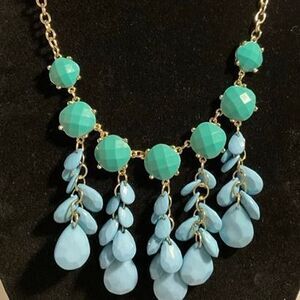 Gold Tone Necklace with Faceted Teal Beads and Light Blue Tassels